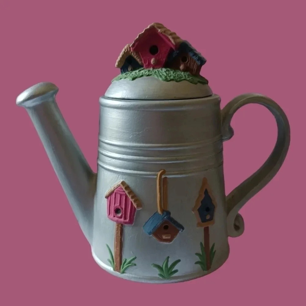 Decorative silver teapot  with house bird lid